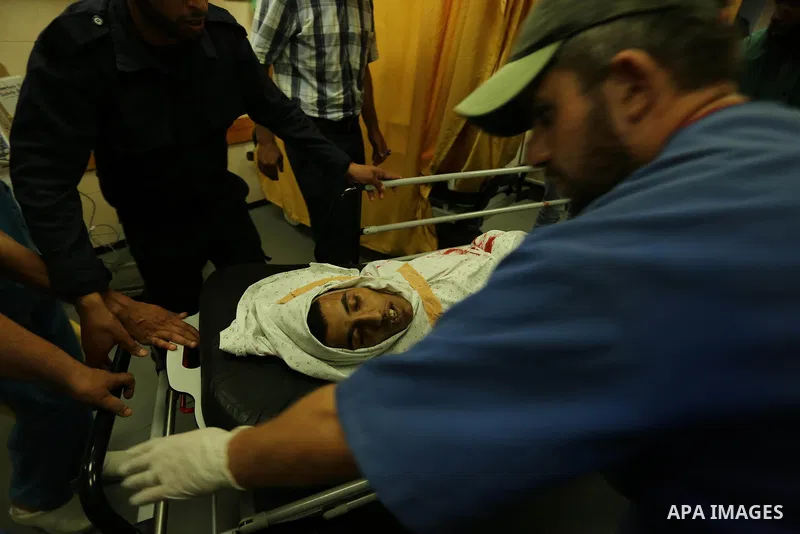 Relatives of a 16-year-old Palestinian, who was reportedly killed in clashes with the Israeli army along the Gaza border, view his body at a hospital in Deir al-Balah in the central Gaza strip on July 28, 2017. Photo by...