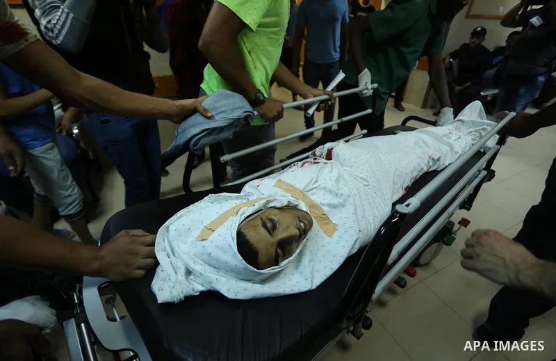 Relatives of a 16-year-old Palestinian, who was reportedly killed in clashes with the Israeli army along the Gaza border, view his body at a hospital in Deir al-Balah in the central Gaza strip on July 28, 2017. Photo by...