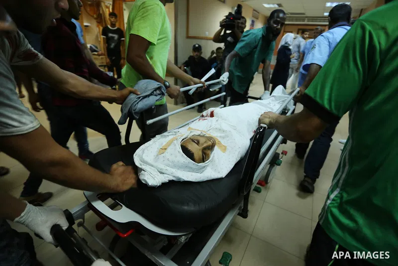 Relatives of a 16-year-old Palestinian, who was reportedly killed in clashes with the Israeli army along the Gaza border, view his body at a hospital in Deir al-Balah in the central Gaza strip on July 28, 2017. Photo by...