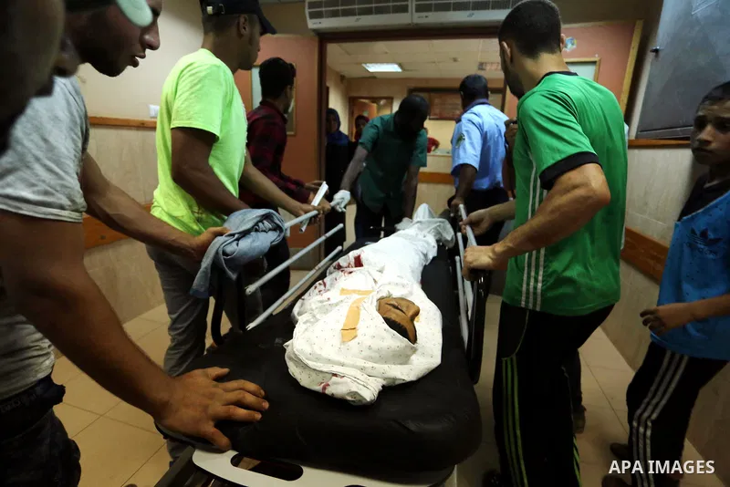Relatives of a 16-year-old Palestinian, who was reportedly killed in clashes with the Israeli army along the Gaza border, view his body at a hospital in Deir al-Balah in the central Gaza strip on July 28, 2017. Photo by...