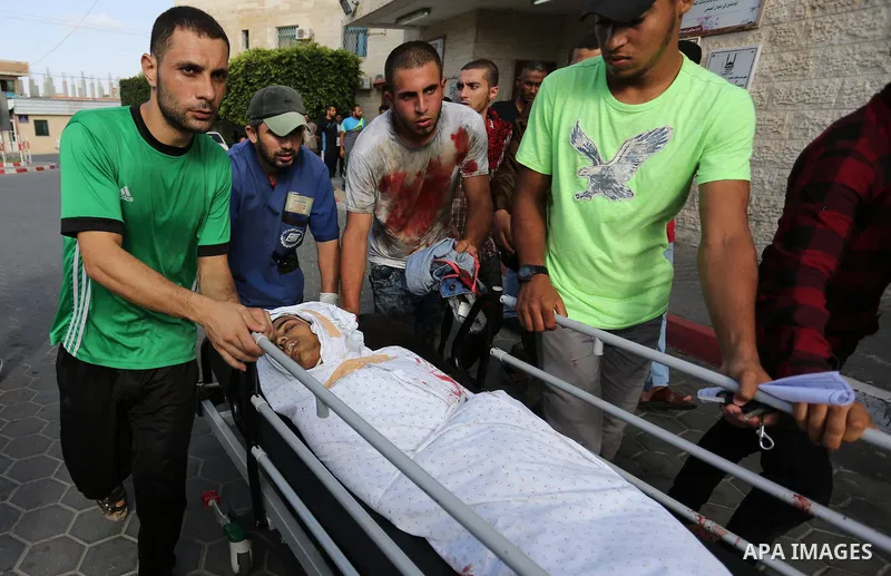Relatives of a 16-year-old Palestinian, who was reportedly killed in clashes with the Israeli army along the Gaza border, view his body at a hospital in Deir al-Balah in the central Gaza strip on July 28, 2017. Photo by...