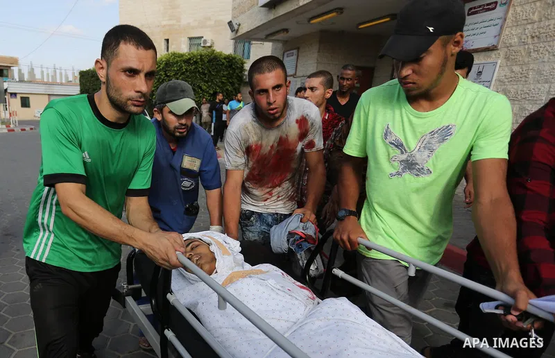Relatives of a 16-year-old Palestinian, who was reportedly killed in clashes with the Israeli army along the Gaza border, view his body at a hospital in Deir al-Balah in the central Gaza strip on July 28, 2017. Photo by...