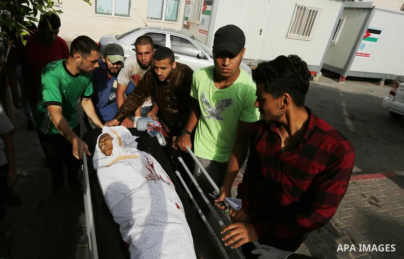 Relatives of a 16-year-old Palestinian, who was reportedly killed in clashes with the Israeli army along the Gaza border, view his body at a hospital in Deir al-Balah in the central Gaza strip on July 28, 2017. Photo by...