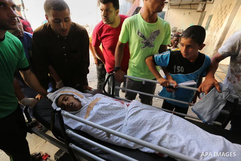 Relatives of a 16-year-old Palestinian, who was reportedly killed in clashes with the Israeli army along the Gaza border, view his body at a hospital in Deir al-Balah in the central Gaza strip on July 28, 2017. Photo by...