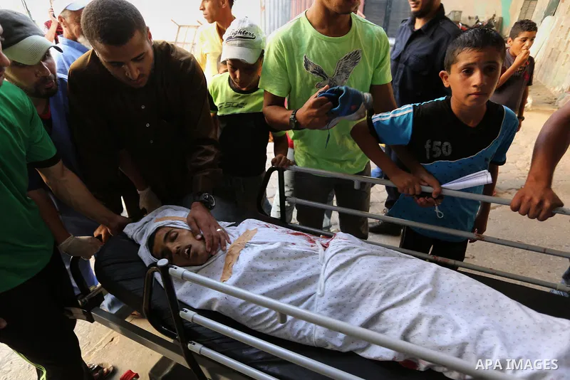Relatives of a 16-year-old Palestinian, who was reportedly killed in clashes with the Israeli army along the Gaza border, view his body at a hospital in Deir al-Balah in the central Gaza strip on July 28, 2017. Photo by...