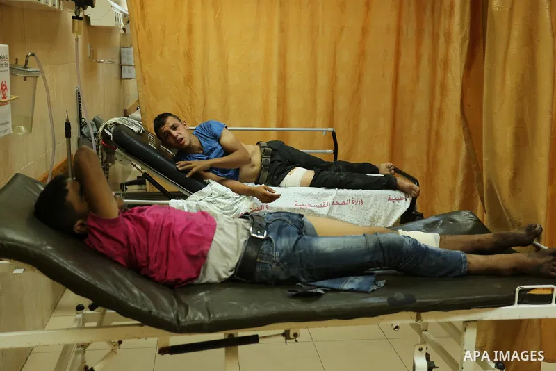 Injured Palestinian protesters, who were wounded during clashes with the Israeli army along the Gaza border, recieves treatment at a hospital in Deir al-Balah in the central Gaza strip on July 28, 2017. Photo by Ashraf A...