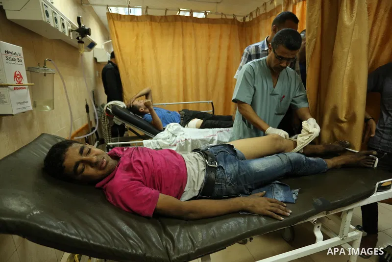 Injured Palestinian protesters, who were wounded during clashes with the Israeli army along the Gaza border, recieves treatment at a hospital in Deir al-Balah in the central Gaza strip on July 28, 2017. Photo by Ashraf A...