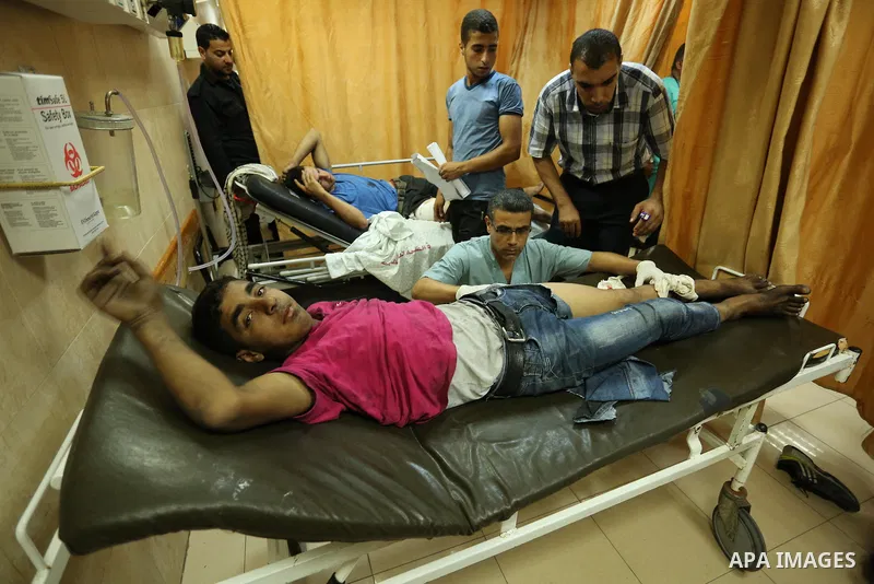 Injured Palestinian protesters, who were wounded during clashes with the Israeli army along the Gaza border, recieves treatment at a hospital in Deir al-Balah in the central Gaza strip on July 28, 2017. Photo by Ashraf A...