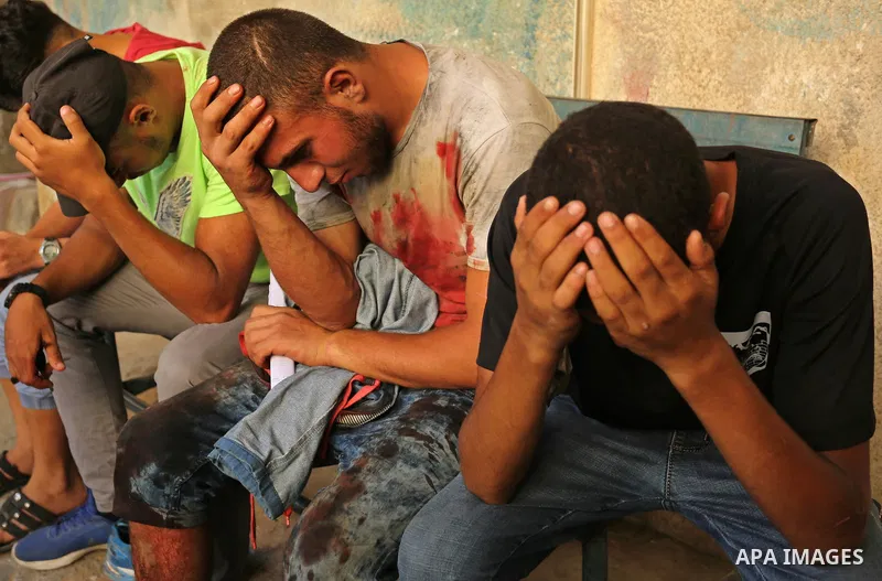 Relatives of a 16-year-old Palestinian who was killed during clashes between Palestinian protesters and Israeli troops, react outside a hospital in center Gaza Strip July 28, 2017. Photo by Ashraf Amra