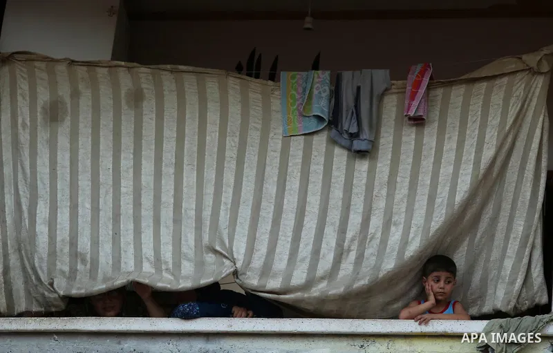 Palestinians watch the funeral of 16 year old Abed Hussian Abu Hasimeh, who was shot dead by Israeli forces during clashes, in the Bureij refugee camp in central Gaza on July 28, 2017. Israeli troops shot dead a Palestin...