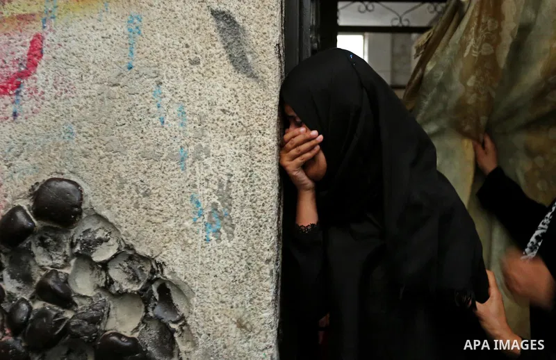 Palestinian relatives of 16 year old Abed Hussian Abu Hasimeh, who was shot dead by Israeli forces during clashes, cry during his funeral in the Bureij refugee camp in central Gaza on July 28, 2017. Israeli troops shot d...