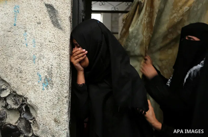 Palestinian relatives of 16 year old Abed Hussian Abu Hasimeh, who was shot dead by Israeli forces during clashes, cry during his funeral in the Bureij refugee camp in central Gaza on July 28, 2017. Israeli troops shot d...