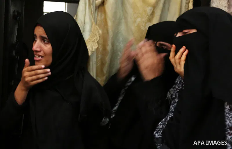 Palestinian relatives of 16 year old Abed Hussian Abu Hasimeh, who was shot dead by Israeli forces during clashes, cry during his funeral in the Bureij refugee camp in central Gaza on July 28, 2017. Israeli troops shot d...