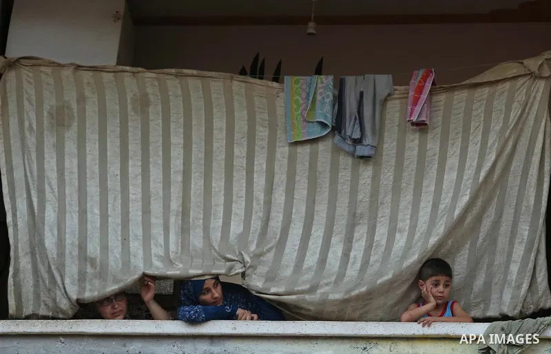 Palestinians watch the funeral of 16 year old Abed Hussian Abu Hasimeh, who was shot dead by Israeli forces during clashes, in the Bureij refugee camp in central Gaza on July 28, 2017. Israeli troops shot dead a Palestin...