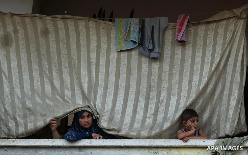 Palestinians watch the funeral of 16 year old Abed Hussian Abu Hasimeh, who was shot dead by Israeli forces during clashes, in the Bureij refugee camp in central Gaza on July 28, 2017. Israeli troops shot dead a Palestin...