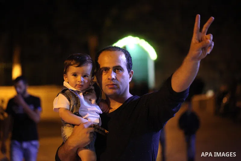 Palestinians celebrate marking Israel's removal of all security measures it had installed at the compound known to Muslims as Noble Sanctuary and to Jews as Temple Mount, in Jerusalem's Old City July 27, 2017. Photo by A...