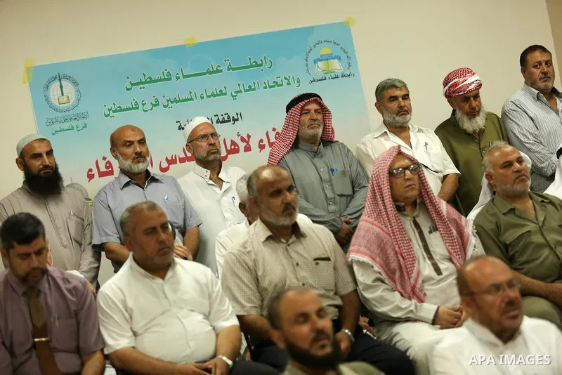 Members of Palestine Scholars Association attend a press conference to show solidarity with Palestinians in Jerusalem, in Gaza city on July 30, 2017. Photo by Ashraf Amra