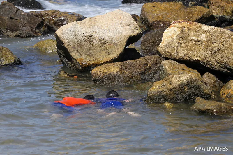 Palestinian boys swim at Gaza seaport in Gaza City on July 31, 2017. Photo by Mohammed Asad