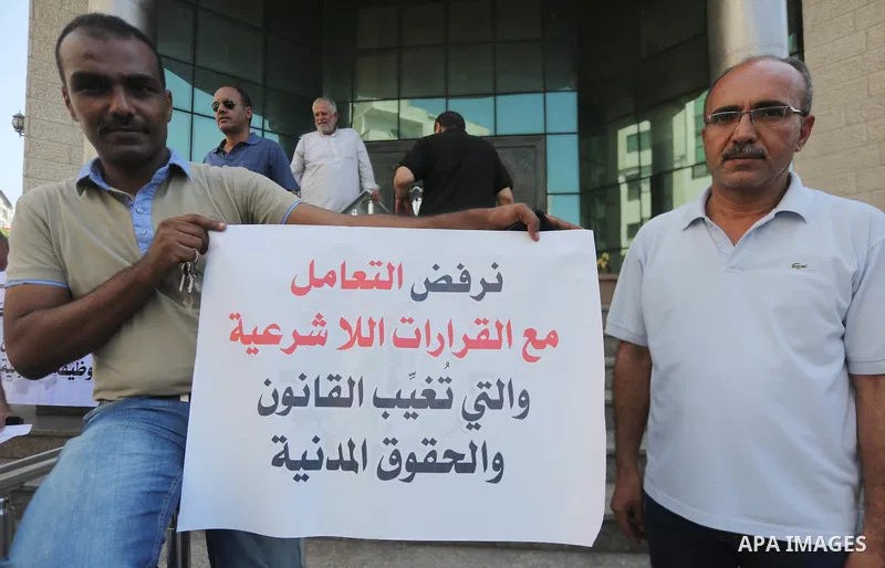 Palestinians, employed by the Palestinian Authority take part in a protest demanding their salaries in Gaza city on August 1, 2017. Photo by Mohammed Asad