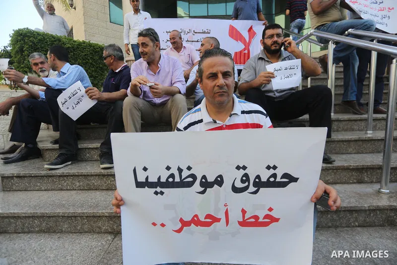 Palestinians, employed by the Palestinian Authority take part in a protest demanding their salaries in Gaza city on August 1, 2017. Photo by Mohammed Asad