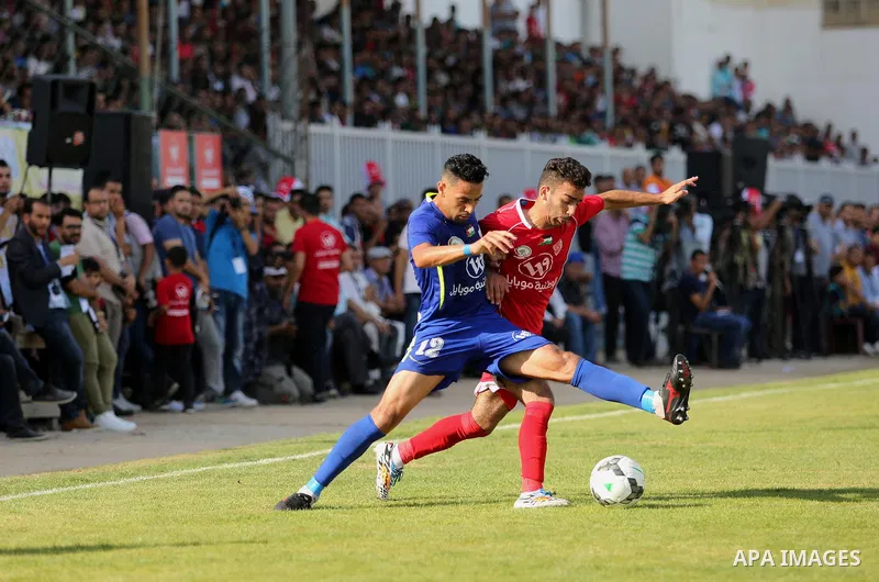 Players of Shabab Rafah football club compete with players of Hebron's Ahly al-Khalil football club in the first leg of the Palestine Cup final at the Yarmouk Stadium in Gaza City on August 1, 2017. Photo by Ashraf Amra