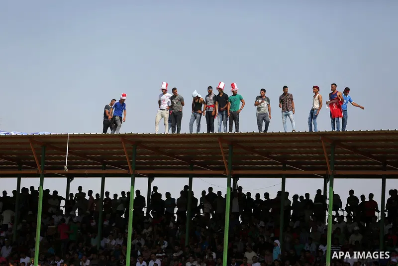 Fans of Shabab Rafah football club watch the first leg of the Palestine Cup final between Shabab Rafah and Hebron's Ahly al-Khalil football club at the Yarmouk Stadium in Gaza City on August 1, 2017. Photo by Ashraf Amra