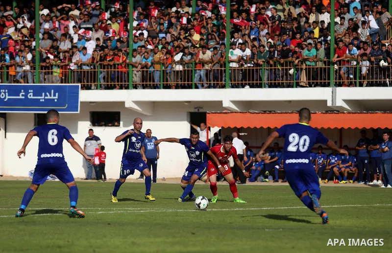 Players of Shabab Rafah football club compete with players of Hebron's Ahly al-Khalil football club in the first leg of the Palestine Cup final at the Yarmouk Stadium in Gaza City on August 1, 2017. Photo by Ashraf Amra