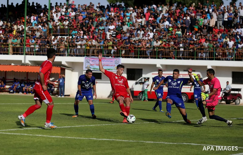 Players of Shabab Rafah football club compete with players of Hebron's Ahly al-Khalil football club in the first leg of the Palestine Cup final at the Yarmouk Stadium in Gaza City on August 1, 2017. Photo by Ashraf Amra