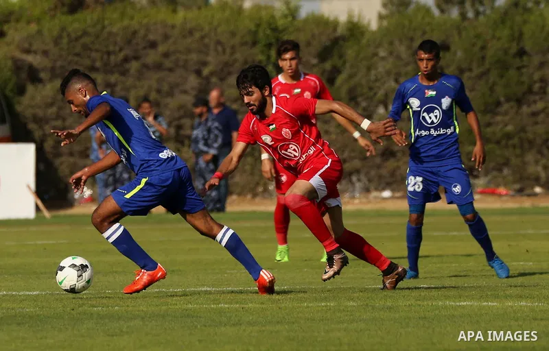 Players of Shabab Rafah football club compete with players of Hebron's Ahly al-Khalil football club in the first leg of the Palestine Cup final at the Yarmouk Stadium in Gaza City on August 1, 2017. Photo by Ashraf Amra
