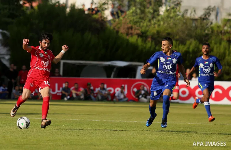 Players of Shabab Rafah football club compete with players of Hebron's Ahly al-Khalil football club in the first leg of the Palestine Cup final at the Yarmouk Stadium in Gaza City on August 1, 2017. Photo by Ashraf Amra