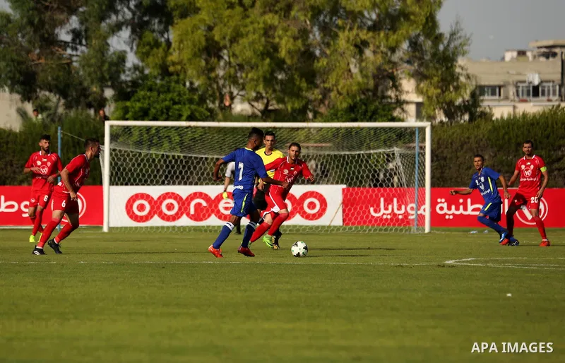 Players of Shabab Rafah football club compete with players of Hebron's Ahly al-Khalil football club in the first leg of the Palestine Cup final at the Yarmouk Stadium in Gaza City on August 1, 2017. Photo by Ashraf Amra