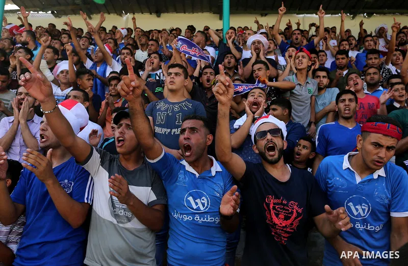 Fans of Shabab Rafah football club watch the first leg of the Palestine Cup final between Shabab Rafah and Hebron's Ahly al-Khalil football club at the Yarmouk Stadium in Gaza City on August 1, 2017. Photo by Ashraf Amra