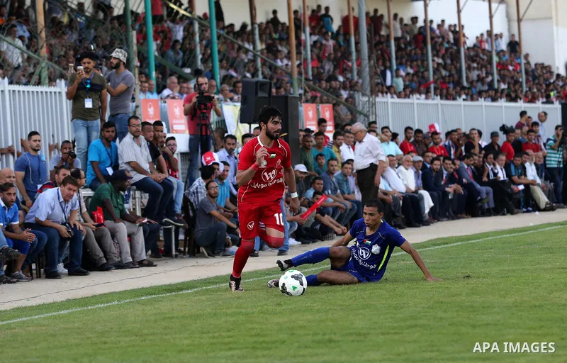 Players of Shabab Rafah football club compete with players of Hebron's Ahly al-Khalil football club in the first leg of the Palestine Cup final at the Yarmouk Stadium in Gaza City on August 1, 2017. Photo by Ashraf Amra