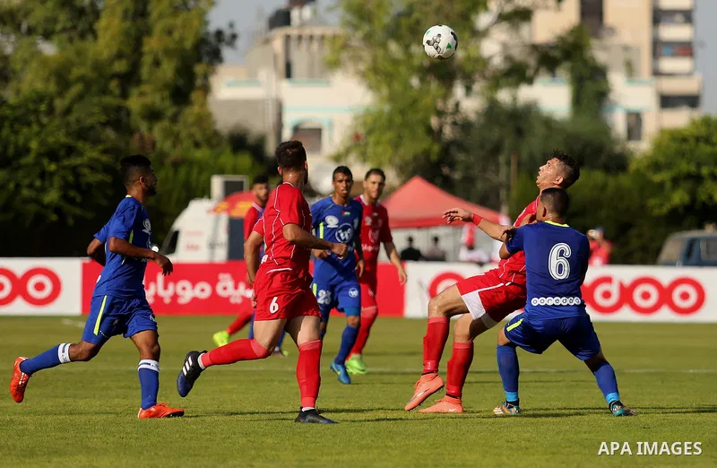 Players of Shabab Rafah football club compete with players of Hebron's Ahly al-Khalil football club in the first leg of the Palestine Cup final at the Yarmouk Stadium in Gaza City on August 1, 2017. Photo by Ashraf Amra