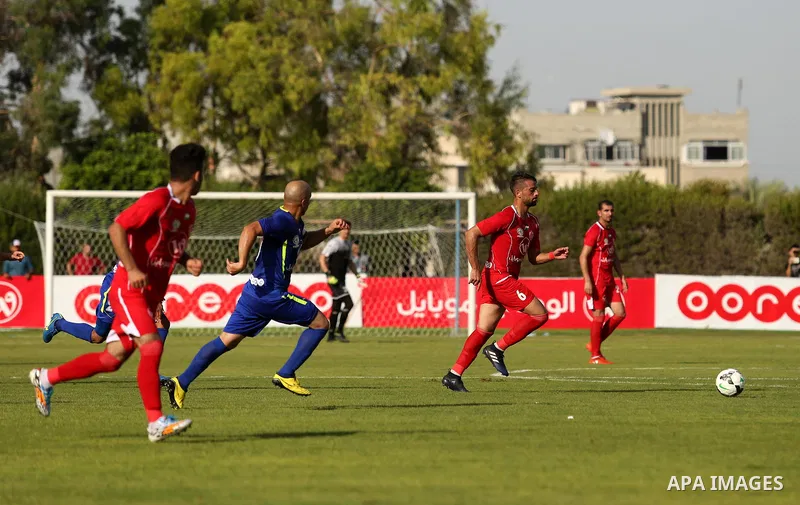 Players of Shabab Rafah football club compete with players of Hebron's Ahly al-Khalil football club in the first leg of the Palestine Cup final at the Yarmouk Stadium in Gaza City on August 1, 2017. Photo by Ashraf Amra