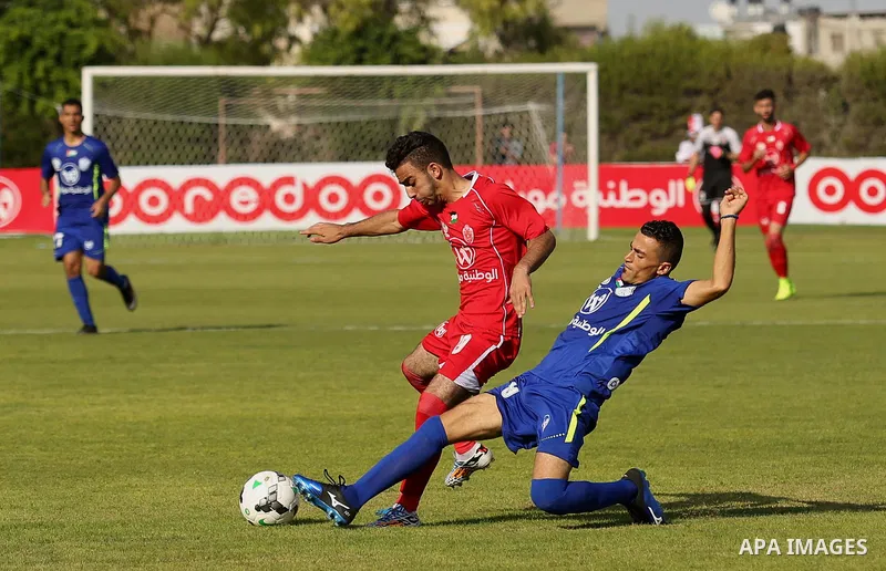 Players of Shabab Rafah football club compete with players of Hebron's Ahly al-Khalil football club in the first leg of the Palestine Cup final at the Yarmouk Stadium in Gaza City on August 1, 2017. Photo by Ashraf Amra