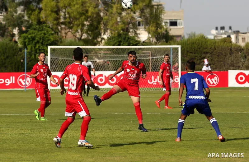 Players of Shabab Rafah football club compete with players of Hebron's Ahly al-Khalil football club in the first leg of the Palestine Cup final at the Yarmouk Stadium in Gaza City on August 1, 2017. Photo by Ashraf Amra