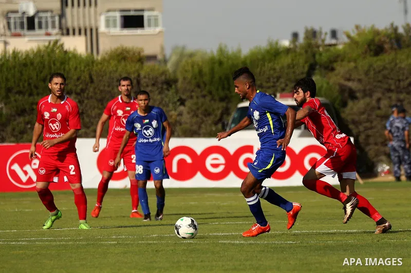Players of Shabab Rafah football club compete with players of Hebron's Ahly al-Khalil football club in the first leg of the Palestine Cup final at the Yarmouk Stadium in Gaza City on August 1, 2017. Photo by Ashraf Amra