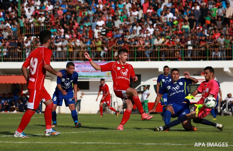 Players of Shabab Rafah football club compete with players of Hebron's Ahly al-Khalil football club in the first leg of the Palestine Cup final at the Yarmouk Stadium in Gaza City on August 1, 2017. Photo by Ashraf Amra