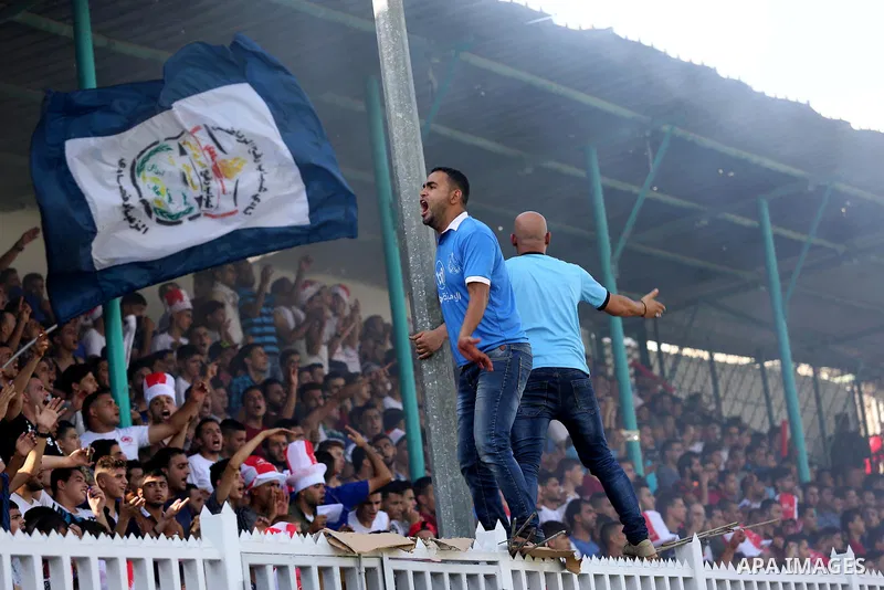 Fans of Shabab Rafah football club celebrate their team's victory against Hebron's Ahly al-Khalil football club in the first leg of the Palestine Cup final at the Yarmouk Stadium in Gaza City on August 1, 2017. Photo by...