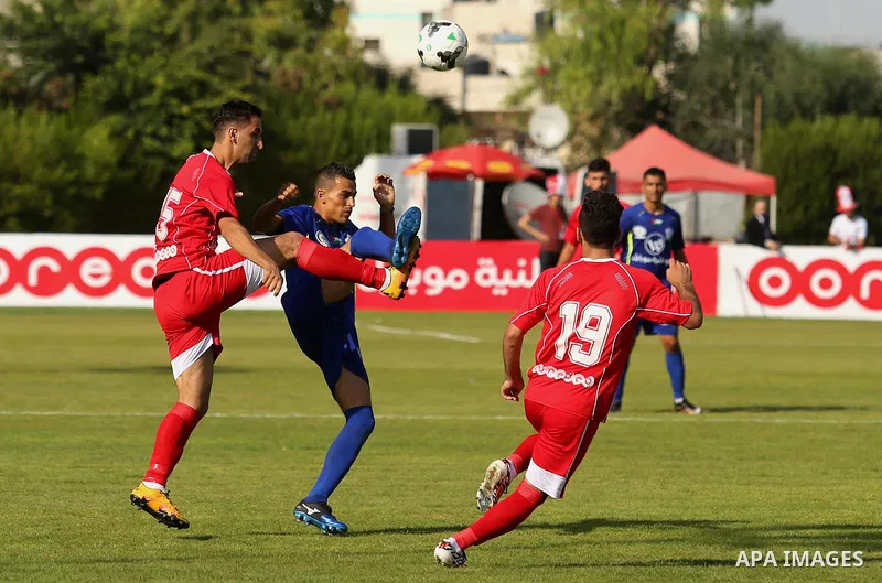 Players of Shabab Rafah football club compete with players of Hebron's Ahly al-Khalil football club in the first leg of the Palestine Cup final at the Yarmouk Stadium in Gaza City on August 1, 2017. Photo by Ashraf Amra