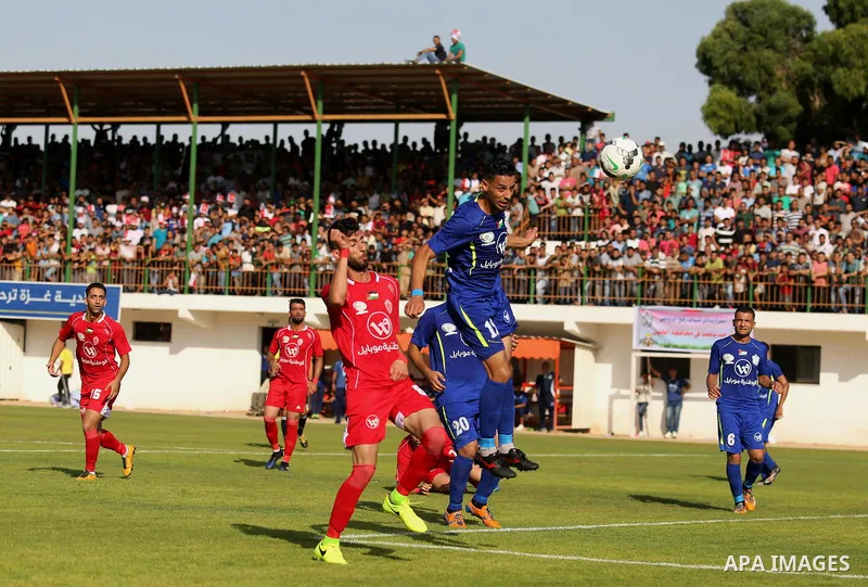 Players of Shabab Rafah football club compete with players of Hebron's Ahly al-Khalil football club in the first leg of the Palestine Cup final at the Yarmouk Stadium in Gaza City on August 1, 2017. Photo by Ashraf Amra
