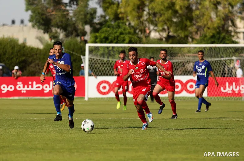 Players of Shabab Rafah football club compete with players of Hebron's Ahly al-Khalil football club in the first leg of the Palestine Cup final at the Yarmouk Stadium in Gaza City on August 1, 2017. Photo by Ashraf Amra