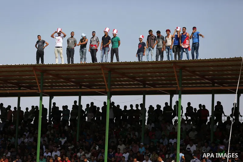 Fans of Shabab Rafah football club watch the first leg of the Palestine Cup final between Shabab Rafah and Hebron's Ahly al-Khalil football club at the Yarmouk Stadium in Gaza City on August 1, 2017. Photo by Ashraf Amra