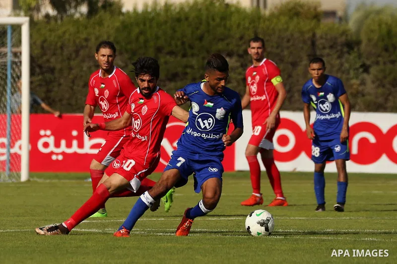 Players of Shabab Rafah football club compete with players of Hebron's Ahly al-Khalil football club in the first leg of the Palestine Cup final at the Yarmouk Stadium in Gaza City on August 1, 2017. Photo by Ashraf Amra