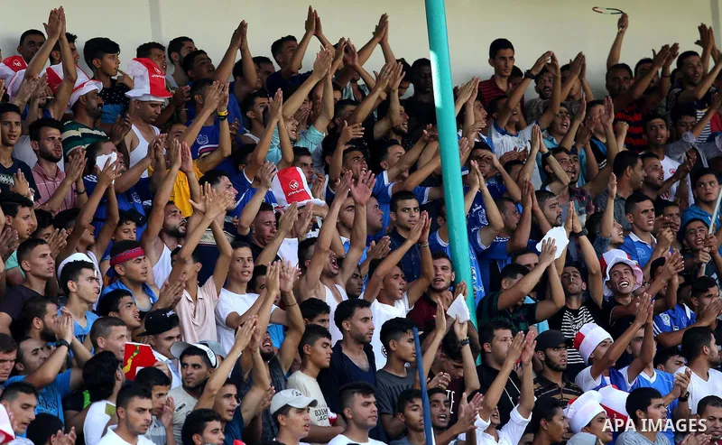 Fans of Shabab Rafah football club celebrate their team's victory against Hebron's Ahly al-Khalil football club in the first leg of the Palestine Cup final at the Yarmouk Stadium in Gaza City on August 1, 2017. Photo by...