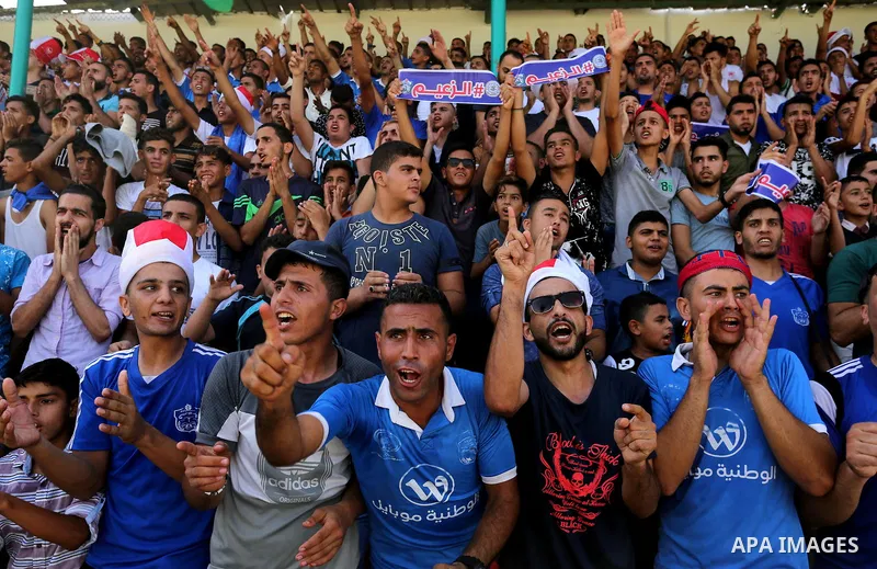 Fans of Shabab Rafah football club watch the first leg of the Palestine Cup final between Shabab Rafah and Hebron's Ahly al-Khalil football club at the Yarmouk Stadium in Gaza City on August 1, 2017. Photo by Ashraf Amra