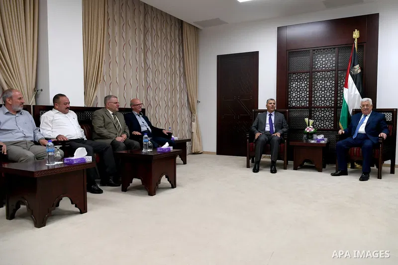 Palestinian President Mahmoud Abbas meets with a delegation from Hamas movement, at his headquarter in the West Bank city of Ramallah on August 01, 2017. Photo by Osama Falah