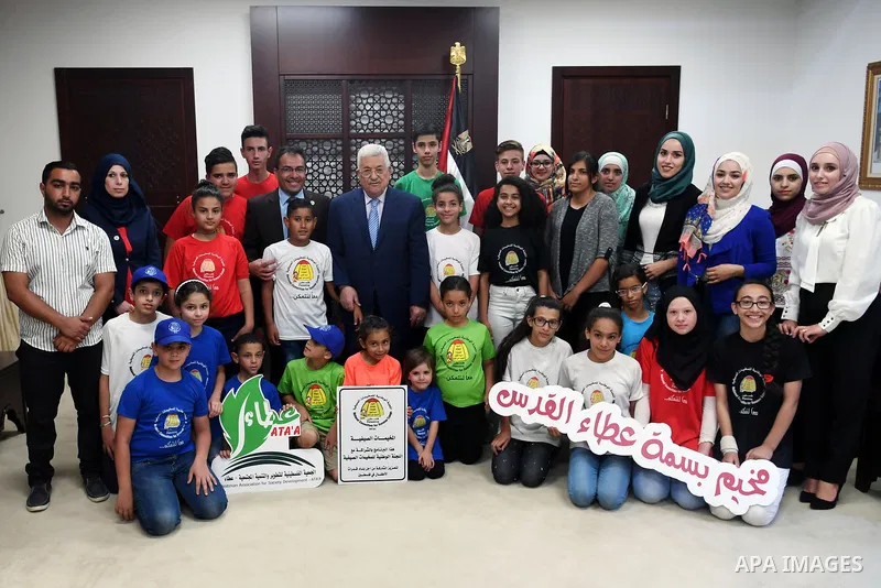 Palestinian President Mahmoud Abbas meets with children of the Basma Ata'a camp, at his headquarter in the West Bank city of Ramallah, on August 2, 2017. Photo by Thaer Ganaim