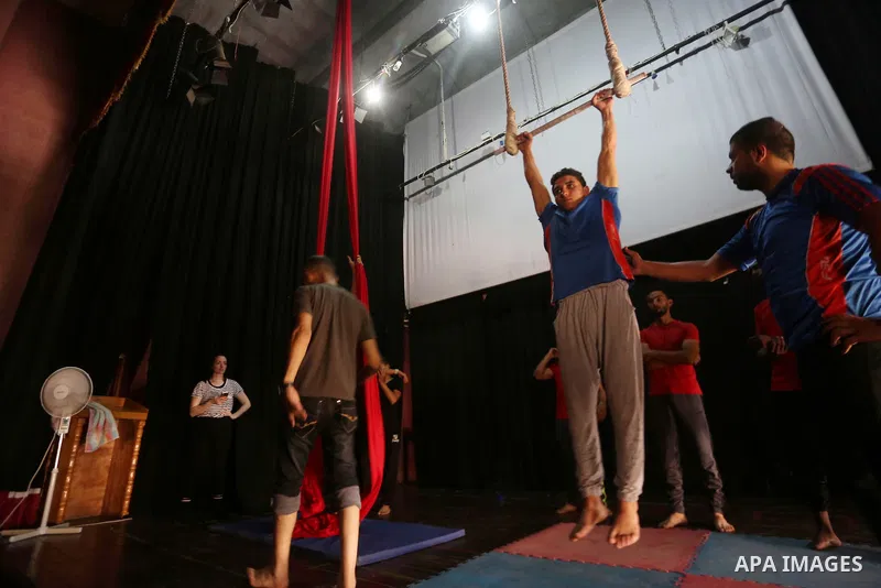 One of the Irish trainer Jennifer Higgins's students from Gaza circus to performs during an aerial silks practice class in Gaza City, on August 3, 2017. Photo by Mohammed Asad